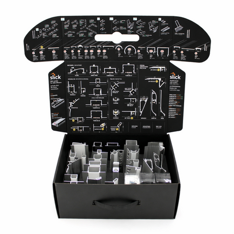 The Topmet LED Channel Sample Case is an open black box with assorted aluminum profile samples for architectural models, plus detailed assembly instructions and diagrams printed on the inside flaps of the lid.