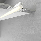 The Recessed Wall Wash LED Lighting Channel ~ Model Acapulco features a white aluminum channel installed under concrete or textured ceilings, emitting bright white light and blending seamlessly for a sleek, modern look.