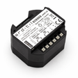 The Casambi Smart Relay with Dual Switch is a black rectangular module featuring terminal connectors, a white label with technical specs including model 808888, electrical ratings, CE marking, and wiring diagrams on its dual actuator design.
