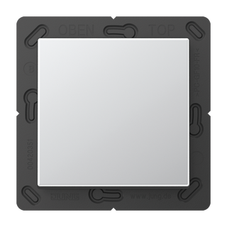 A square, silver Casambi 1-Button Wireless Wall Switch (Model Jung BLE A 590) is mounted on a black plastic frame with visible markings and slots around the edges.