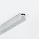 A length of 0.51″ Suspended/Surface Mount Bendable LED Channel ~ Model Bend8 with a silver-toned aluminum grooved profile mounted on a white surface.