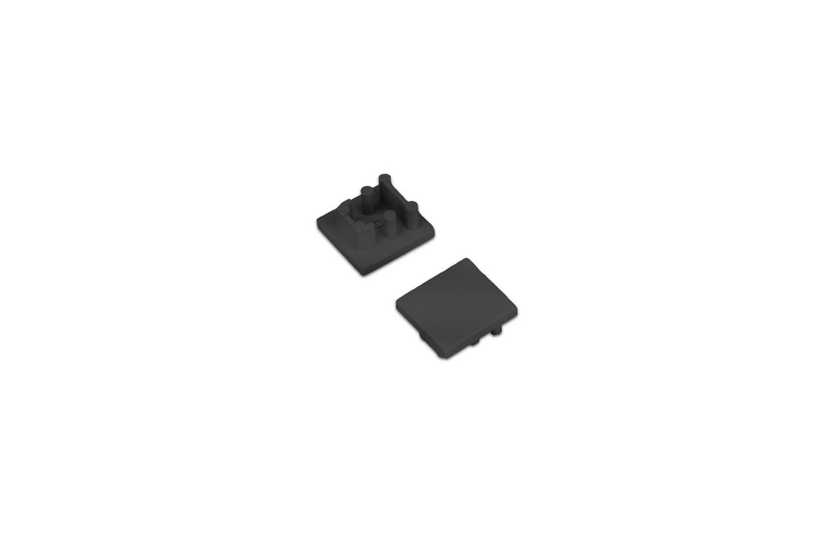 Two small black ABS End Cap for Bend8 Profile pieces, one shown from the top and the other from the underside with mounting pegs.