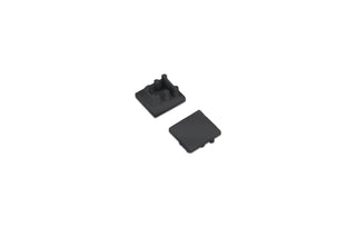 Two small black ABS End Cap for Bend8 Profile pieces, one shown from the top and the other from the underside with mounting pegs.