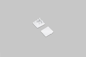 Two small white square End Cap for Bend8 Profile pieces, one shown from the top and one shown from the underside with mounting pegs.