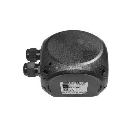 A black AC-powered Satellite Time Source for Casambi networks (Model CBU-SKYTIME-IP) with two cable connectors and a label, featuring Bluetooth Low Energy, displayed on a white background.