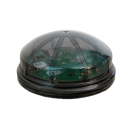 The Zhaga B18 Satellite Time Source for Casambi Networks (Model CBU-SKYTIME-ZG) is a round, black plastic device with a transparent domed cover, revealing green circuit boards and featuring a sleek, futuristic design for time synchronization.