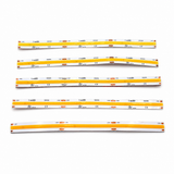 Six yellow and white flexible COB IP20 Dotless LED Strip (24V) ~ UniBasic Series light strips are laid out on a white surface, each labeled with technical specifications and featuring small orange sections evenly spaced along their lengths. Incorporating advanced 24V dotless LED strip technology, these high CRI LED strips provide smooth, consistent illumination that’s ideal for precise lighting applications.