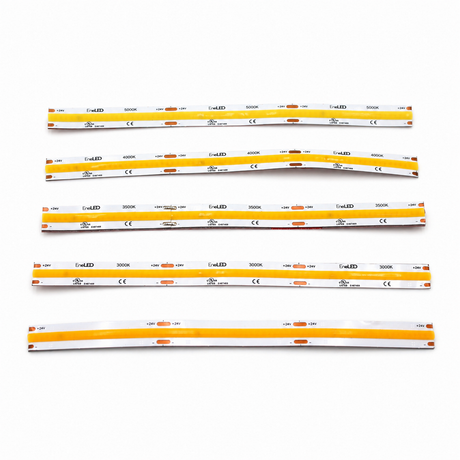Six yellow and white flexible COB IP20 Dotless LED Strip (24V) ~ UniBasic Series light strips are laid out on a white surface, each labeled with technical specifications and featuring small orange sections evenly spaced along their lengths. Incorporating advanced 24V dotless LED strip technology, these high CRI LED strips provide smooth, consistent illumination that’s ideal for precise lighting applications.
