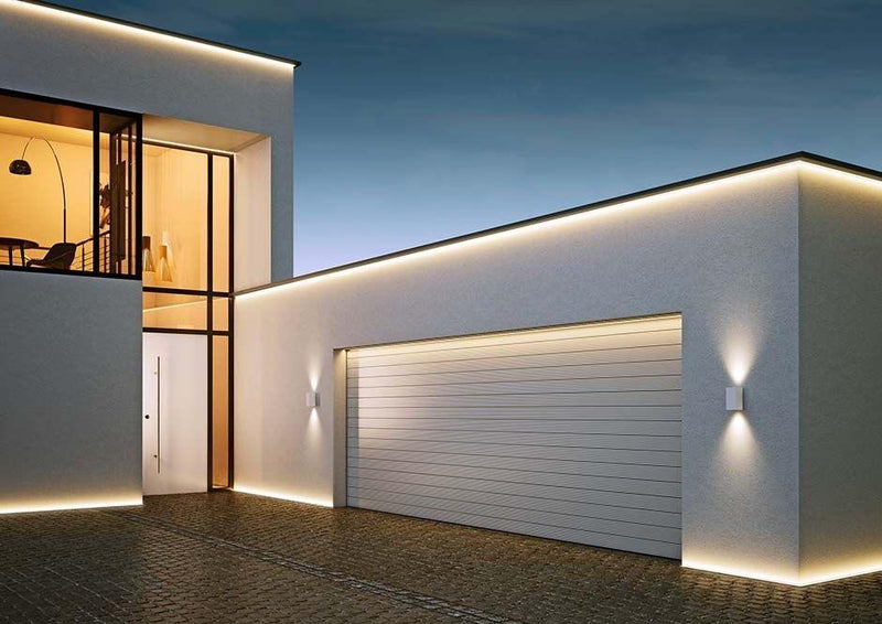 Contemporary home exterior with LED strip lights and aluminium heat sinks outlining the roofline for elegant architectural lighting.