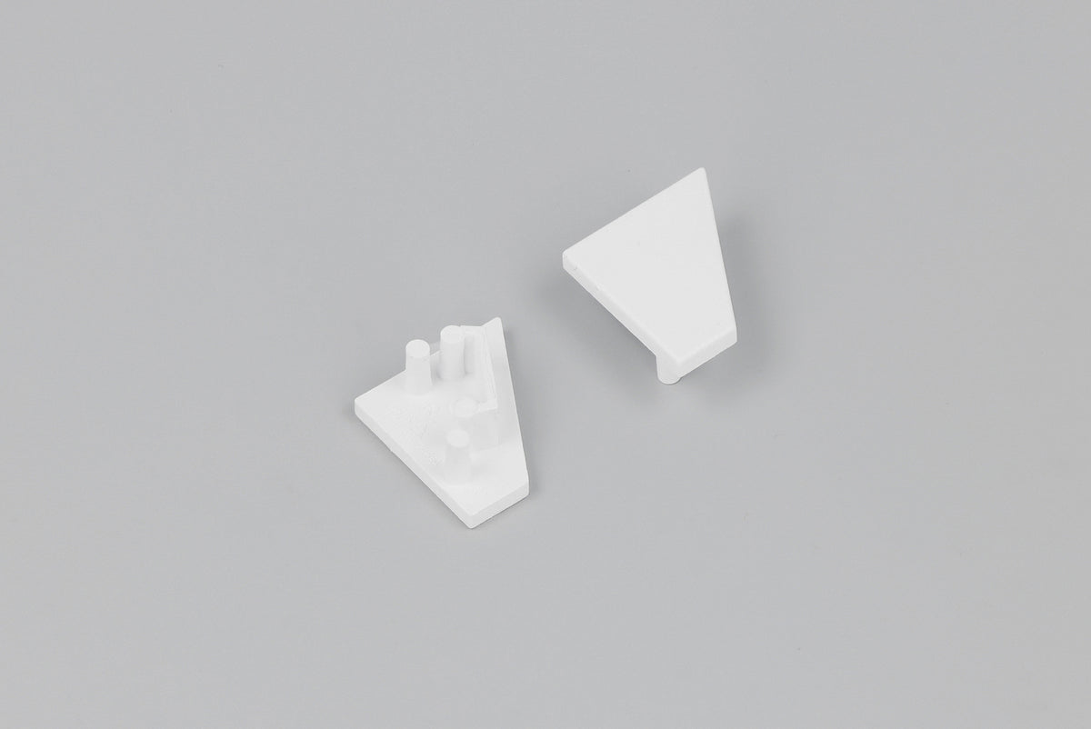 Two small, white, triangular plastic components—each an End Cap for the Corner10.v2 Profile lighting fixture—are displayed on a plain gray background. One end cap is flat, while the other features three short cylindrical pegs on its surface.