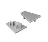 Two gray plastic triangular pieces—one with pegs and a slot below, the other smooth—are shown as End Caps for the Corner12.v2 Profile, ideal for use in lighting fixture assemblies.