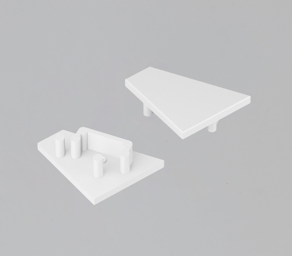 Two white, triangular End Caps for the Corner12.v2 Profile are displayed on a gray background. One has a smooth surface with two pegs below, and the other features three pegs plus a rectangular slot for a lighting fixture.