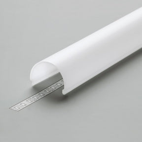 The LED Channel Cover ~ D9 Click, a white semi-circular cover made of durable PMMA, rests on a gray surface and partially conceals a silver LED strip with small visible bulbs.
