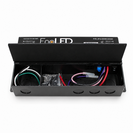 Black metal electrical box labeled Enoled JPro Series with its lid open, showing wiring, connectors, mounting holes inside, and equipped with the 5-in-1 Dimmable J-Box LED Driver (24V) for versatile lighting installations.