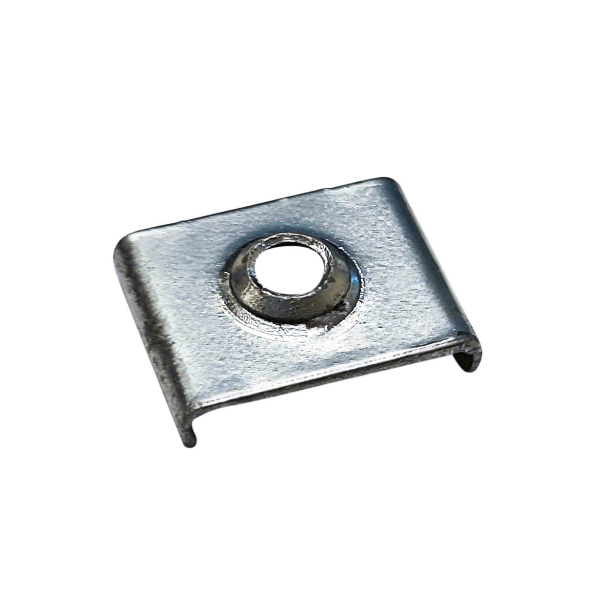 The Steel Mounting Clip for Galicia Profile is a small rectangular steel clip featuring a central raised circular hole and two short bent flanges on opposite sides, shown isolated on a white background.
