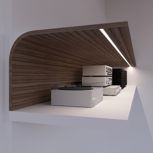 A modern wooden shelf with a built-in LED light, featuring the sleek 0.42″ Recessed LED Channel ~ Model Groove10.v2 aluminum profile, holds a white turntable and stacked audio equipment against a white wall.