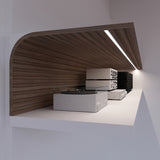 A modern wooden shelf with a built-in LED light, featuring the sleek 0.42″ Recessed LED Channel ~ Model Groove10.v2 aluminum profile, holds a white turntable and stacked audio equipment against a white wall.