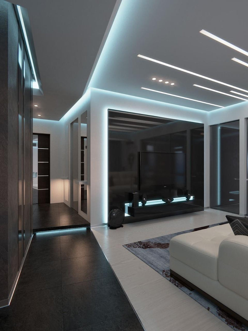High-end living room and media wall featuring indirect cool white LED strip lighting around the ceiling and TV unit for a futuristic atmosphere.