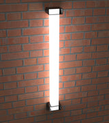 A Surface Mounting Bracket for Holston74 Tube Profile is installed on a red brick wall, casting a bright white glow and illuminating the surrounding bricks.