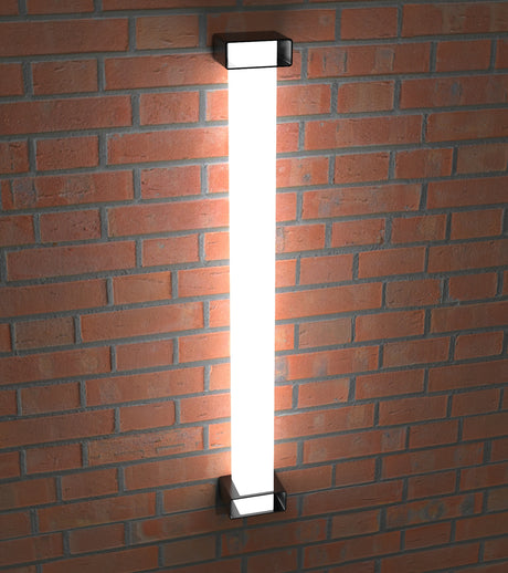 A Surface Mounting Bracket for Holston74 Tube Profile is installed on a red brick wall, casting a bright white glow and illuminating the surrounding bricks.