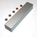 A Custom PL55 J-Box is set on a white surface, surrounded by six small orange and transparent wire connectors for secure electrical connections.