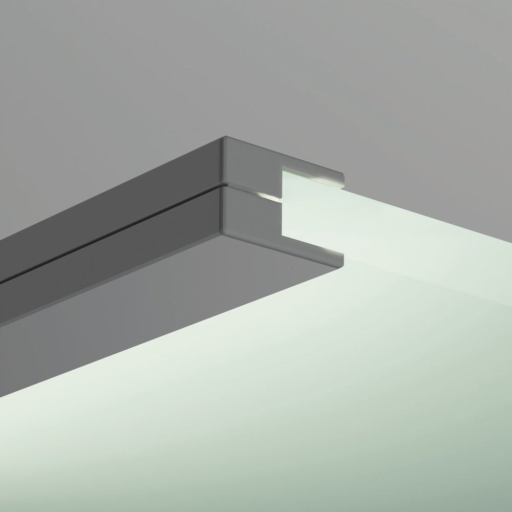 Close-up of a frosted glass panel edge fitted with the End Cap for KRAV-05IN Profile, set in a sleek metal frame with channel against a plain gray background.