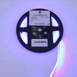 The 450nm COB IP20 LED Strip For Medical Lighting (5V) ~ Aloe Vera Series emits vibrant blue light ideal for phototherapy, features a technical label and a date sticker (08/05/2025), and is shown partially unrolled and brightly glowing.
