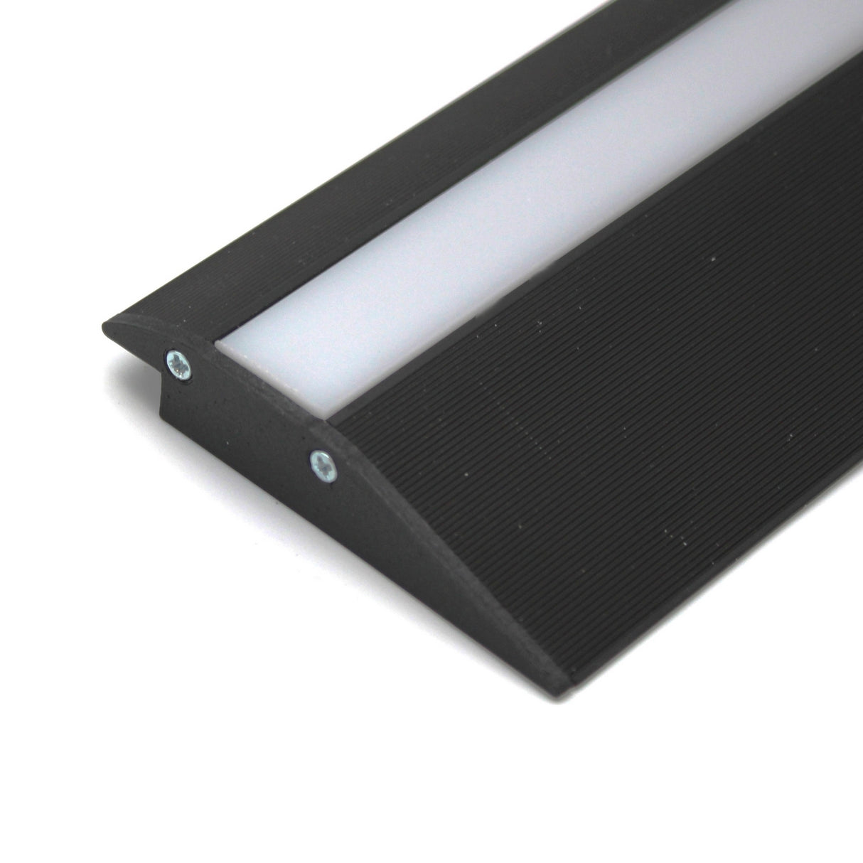A close-up of the Floor Transition Strip LED Channel ~ Model Broadway, a black angled treadable profile with a white diffuser panel and two screws, designed to provide illuminated edge protection for stairs.
