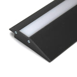 A close-up of the Floor Transition Strip LED Channel ~ Model Broadway, a black angled treadable profile with a white diffuser panel and two screws, designed to provide illuminated edge protection for stairs.