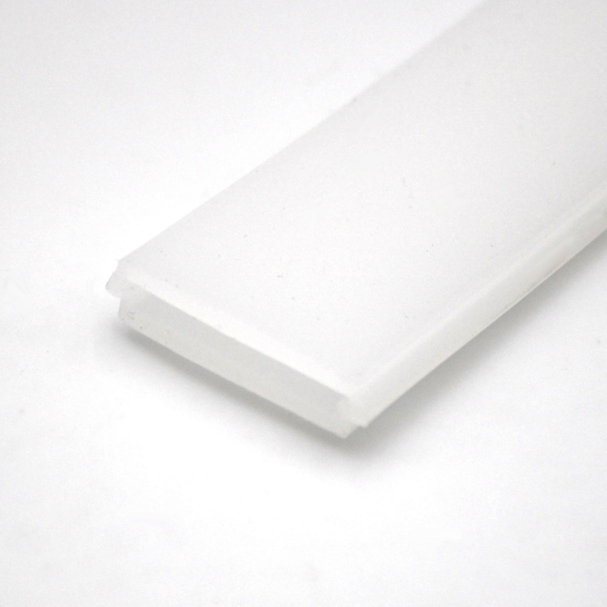 A close-up of the LED Channel Cover for KOZUS-BD Profile shows its white, rectangular plastic design with beveled edges, photographed against a plain white background—ideal for modern lighting solutions.