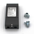 A black Dimmable Class 2 Electronic LED Driver (24V) ~ Magnitude E Series with a white label sits on a white surface beside two metal cable connectors. The label shows input/output info and supports phase dimming or TRIAC controls.
