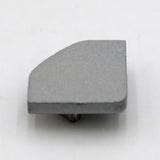 The Single End Cap for LED Channel ~ Alu-45 is a small, flat gray metal cap with an angled edge and bottom peg, shown on a white surface—perfect for completing your Alu-45 lighting fixture.