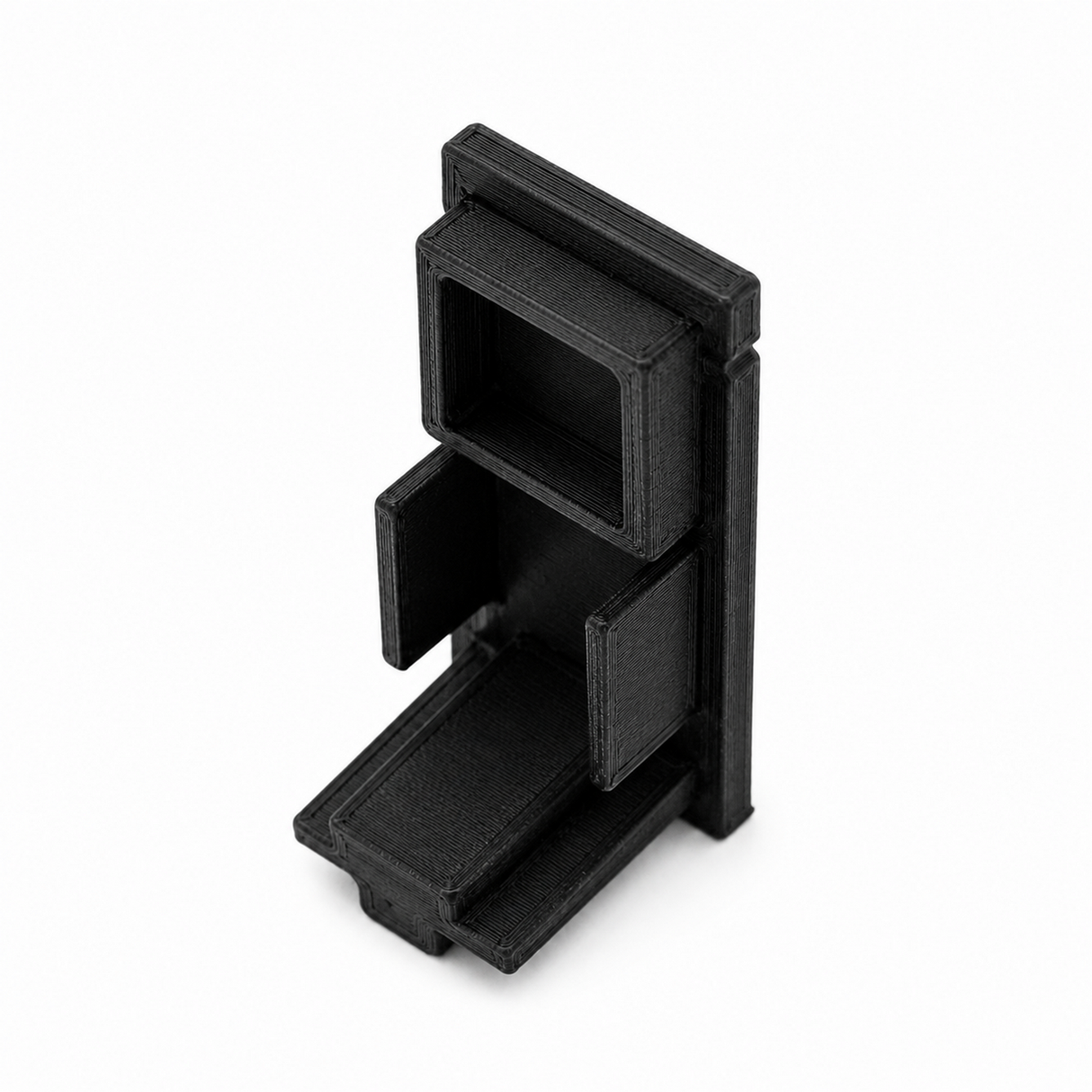 A black, rectangular Plastic End Cap for Hannover Profile with multiple open compartments and angled sections, 3D printed and shown standing upright on a white background.