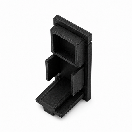 A black, rectangular Plastic End Cap for Hannover Profile with multiple open compartments and angled sections, 3D printed and shown standing upright on a white background.
