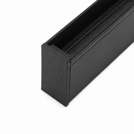 Close-up of a black Plastic End Cap for Hannover Profile, 3D printed with a textured finish. The rectangular cap is partially open, revealing its dark interior, and is set against a white background.