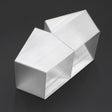 Two geometric, brushed silver Holston74 profile housings are joined side by side with a Translucent Elbow for Holston74 Profile, forming an abstract modern design against a black background.