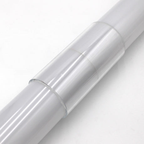 A close-up of the Clear Straight Joiner for Smokies65 Profile, a clear plastic adhesive film roll designed for LED profile joints, placed on a white surface beside a round LED profile connector.
