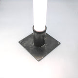 The Steel Base for 2.56" Round Profiles is a sturdy steel plate with four bolt holes, designed to mount a round diffuser tube vertically as a secure floor stand on flat surfaces.