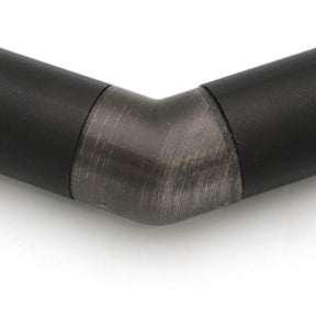 Close-up of a Translucent Elbow for Oslo Profile, showing the 90-degree angled connector joining black metal pipes. The transition between straight sections is clear against a white background.