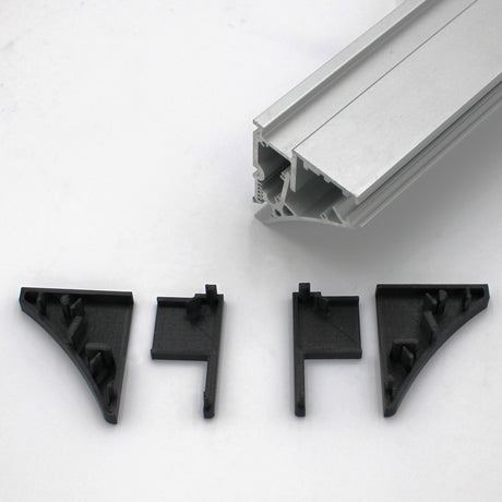 A silver Pula P10 edge-lit shelf profile sits above three black plastic corner brackets and an End Cap for Pula P10 Profile, all arranged on a white background. The brackets and end cap are designed to fit the extrusion.