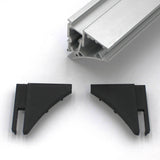 A close-up of the End Cap for Pula P10 Profile with two black plastic corner connectors and an aluminum extrusion, all on a white surface—ideal for finishing the Pula P10 edge-lit shelf profile.