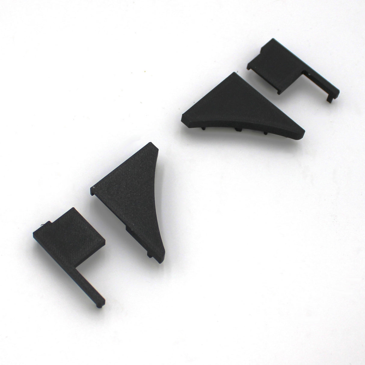 Four End Caps for Pula P10 Profile, made of black plastic in different shapes, are arranged in a row on a white background.