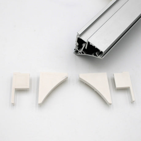 A silver Pula P10 edge-lit shelf profile extrusion bar with a hollow design is shown above four white End Caps for the Pula P10 Profile, each made of PETG plastic in different shapes, all on a white background.