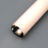 A close-up of the 1.50" Round Acrylic LED Tube ~ Model Sierra38, a sleek cylindrical gold-light with LED diffuser tube, powered on and resting on a smooth gray surface.