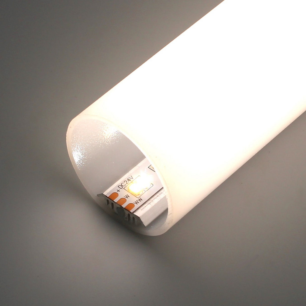 A close-up of the glowing 1.50" Round Acrylic LED Tube ~ Model Sierra38, featuring an LED strip inside a frosted cylindrical diffuser, with part of the LED strip visible through the open end.