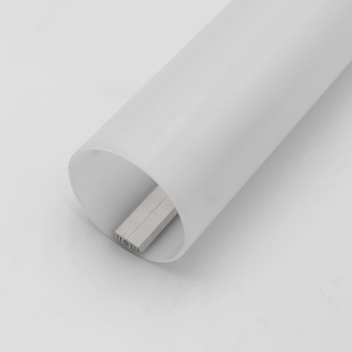 A close-up of the Sierra65 2.56 Round Acrylic LED Lighting Tube shows a white cylindrical diffuser with a rectangular metal bar partially inserted, resting on a plain white surface.