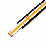 A close-up of the COB IP20 Dotless LED Strip (24V) ~ UniBasic Series mounted in a black and white aluminum channel, shown on a white background.