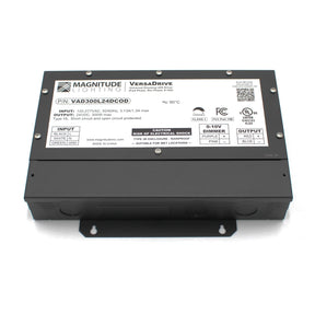 A black 5-Way Universal Dimmable Constant Voltage LED Driver (24V) ~ Magnitude VersaDrive features labeled input, output, and dimmer info, specs, warnings, certification symbols, and supports universal dimming for flicker-free performance.