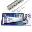 The RGB LED Tile Light Strip Kit for Outside Corners (24V) ~ Nicho Series is shown packaged next to a white corner trim with holes, ideal for mounting aluminum LED channels, and includes two small white plastic end caps.