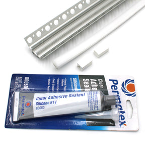 A tube of Permatex Clear Adhesive Sealant Silicone RTV with packaging is shown beside white trim pieces and two small white clips from the RGB LED Tile Light Strip Kit for Inside Corners (24V) ~ Nicho Series, all on a white background.